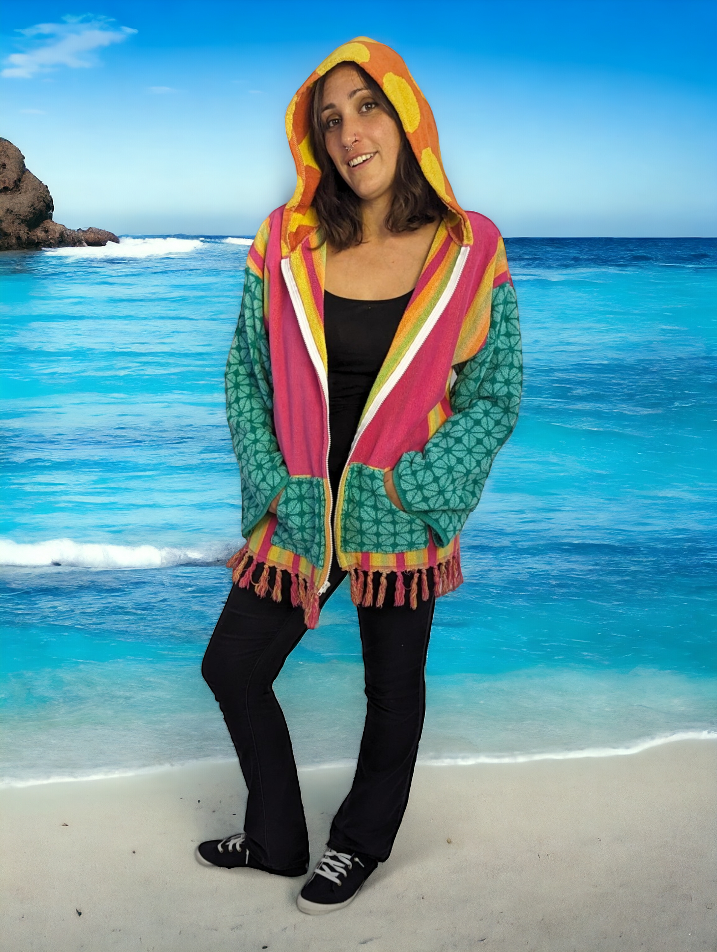 woman on beach wearing upcycled towel hoodie.