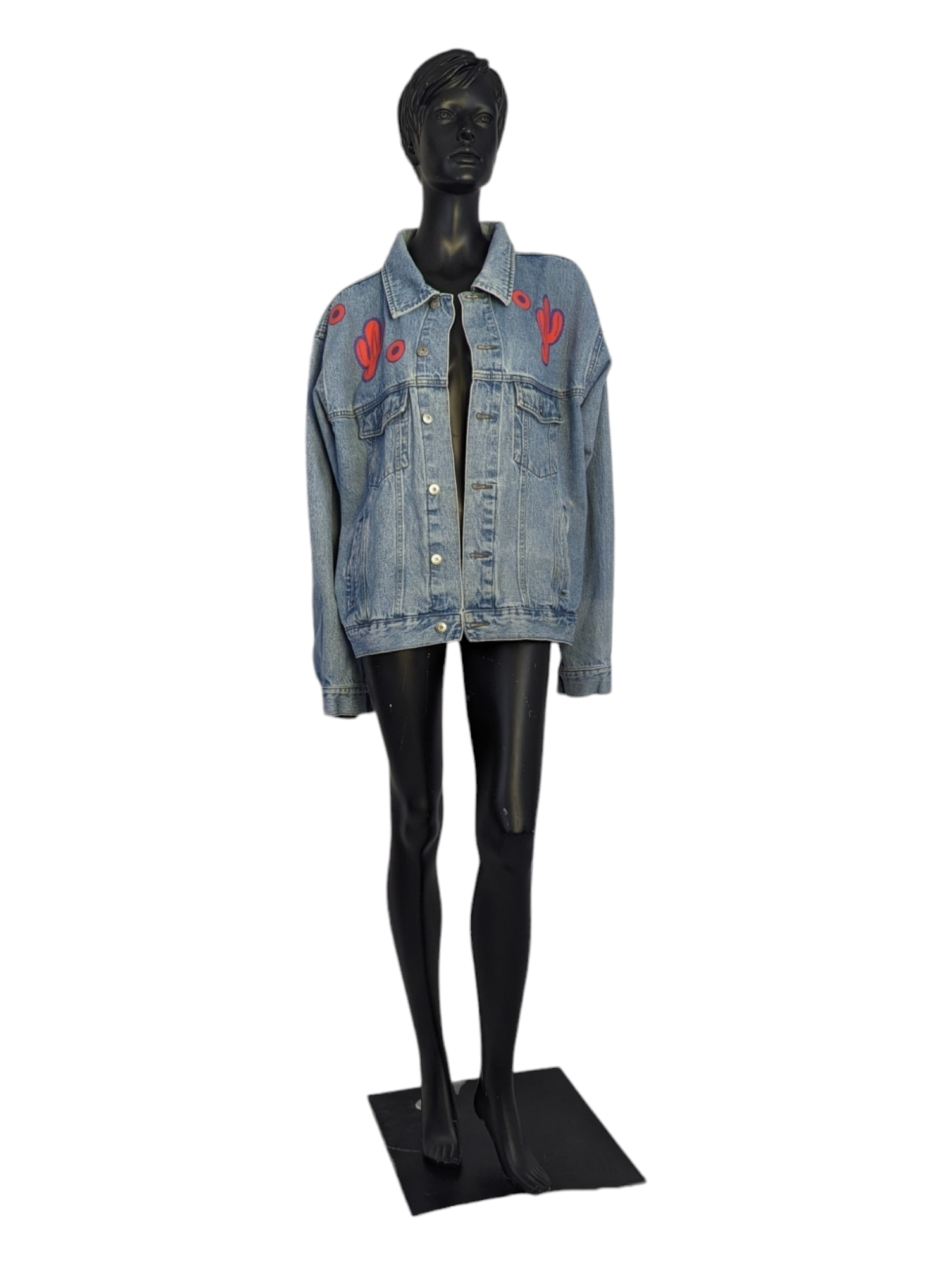 Front view of mannequin wearing denim jacket with cactus patches