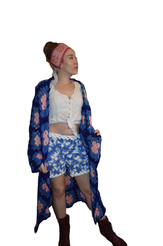 Woman is wearing a pair of wide leg shorts made from upcycled crochet blanket.