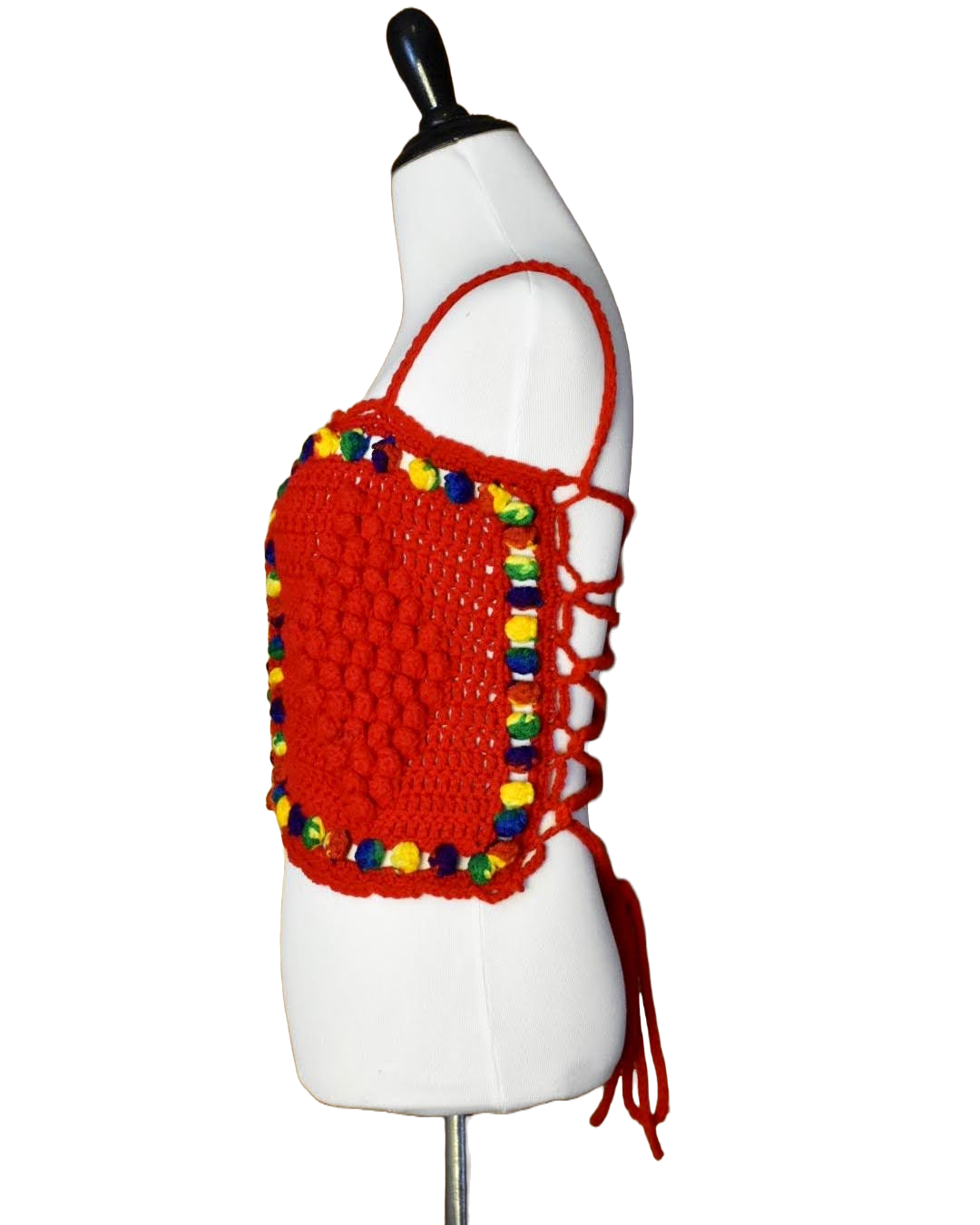 Side view of dress form displaying a red and rainbow crochet lace up top.
