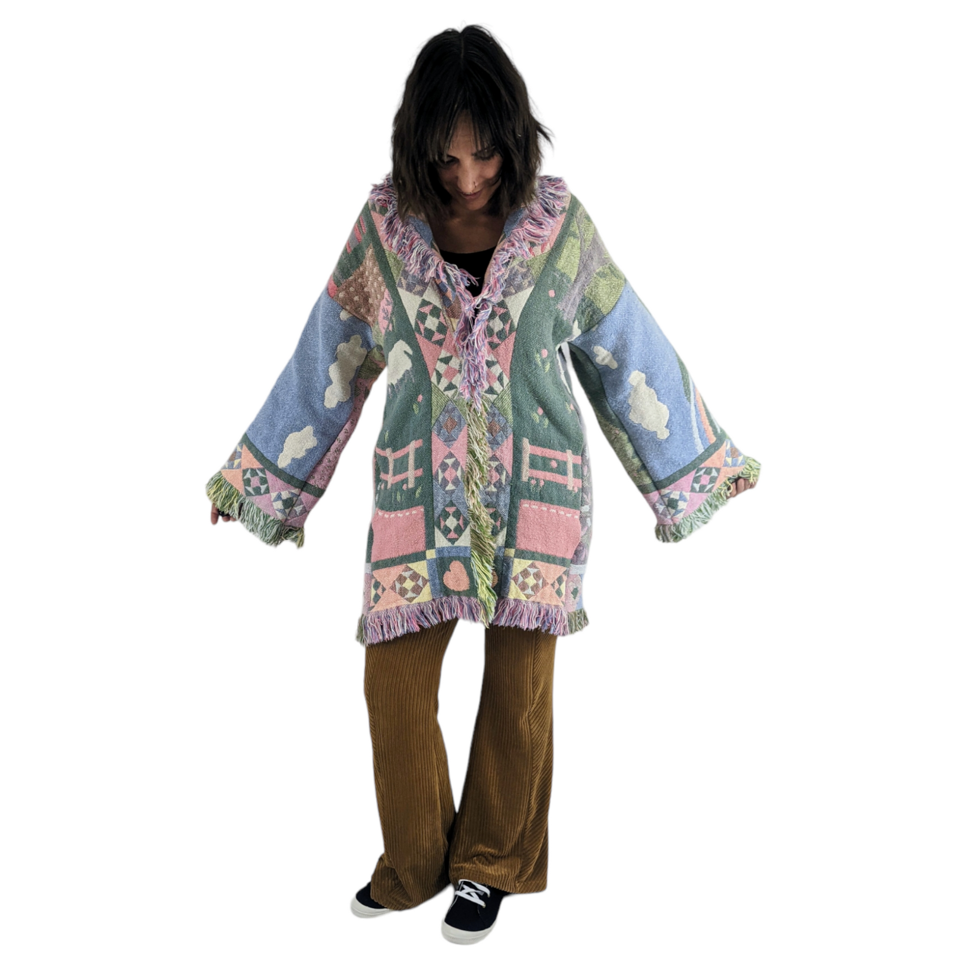 Front view of woman wearing blanket coat with patchwork quilt pattern.