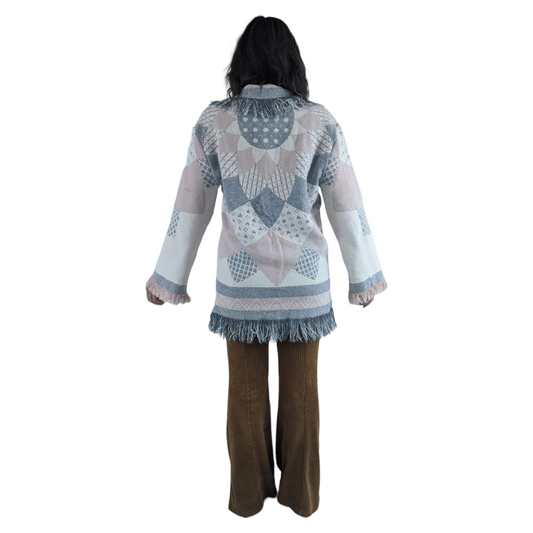 Rear view of woman wearing quilt coat tapestry blanket coat.
