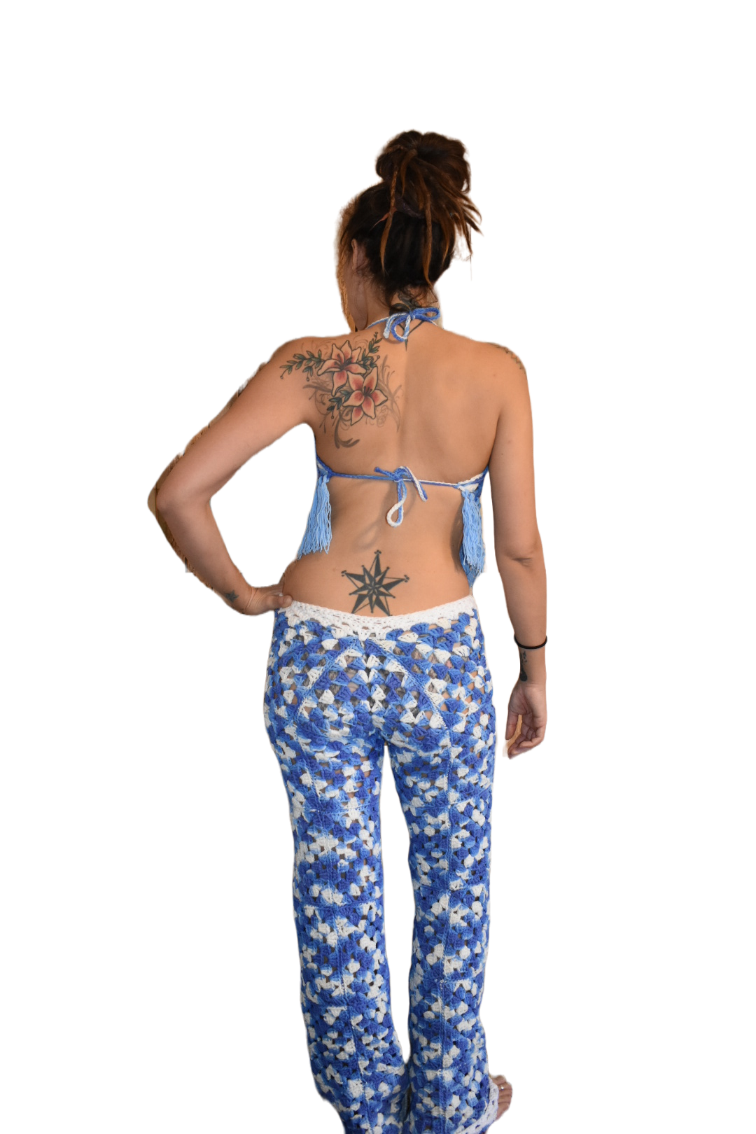 Back view of woman wearing blue ombre crochet wide leg pants.