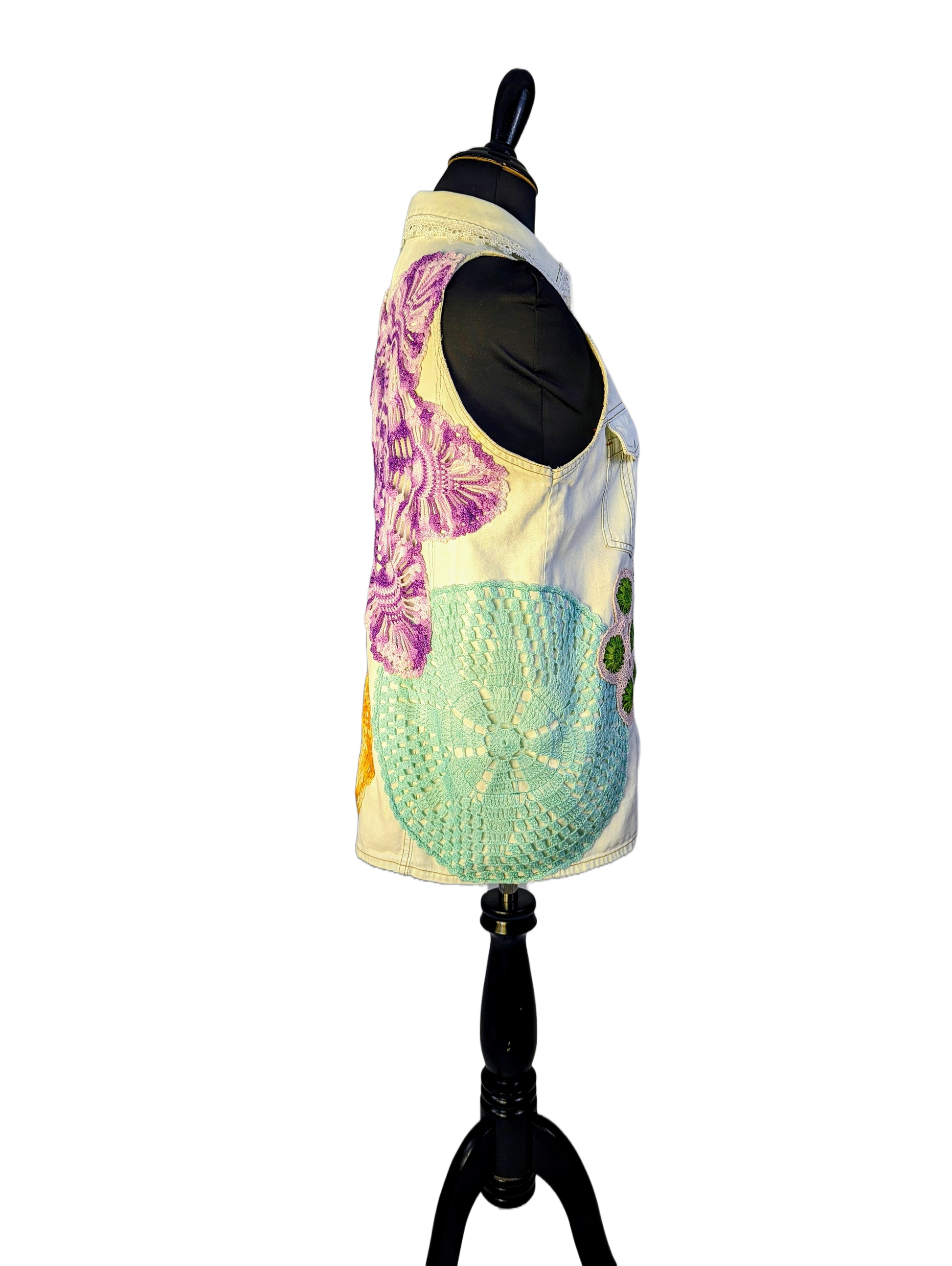 Side view of dress from displaying white vest with teal and purple doilies.