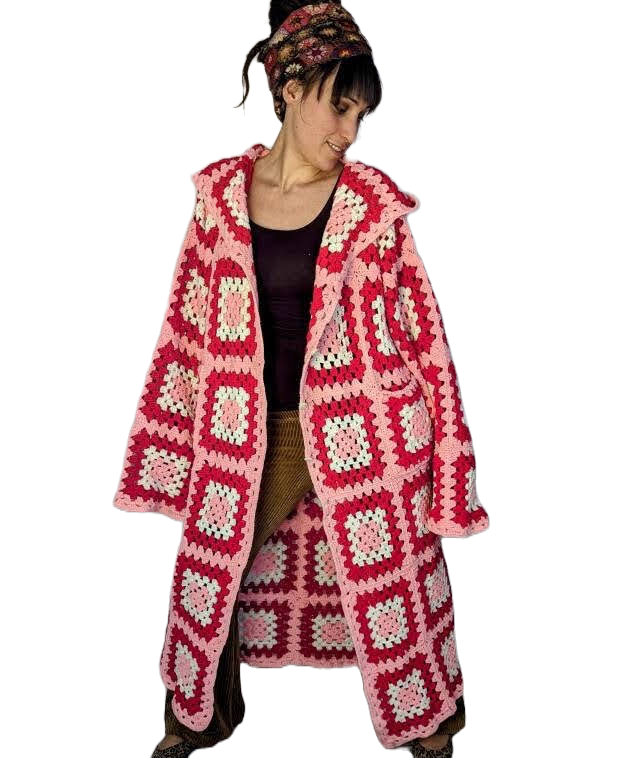 A woman wears a one-of-a-kind coat made from recycled clothing.